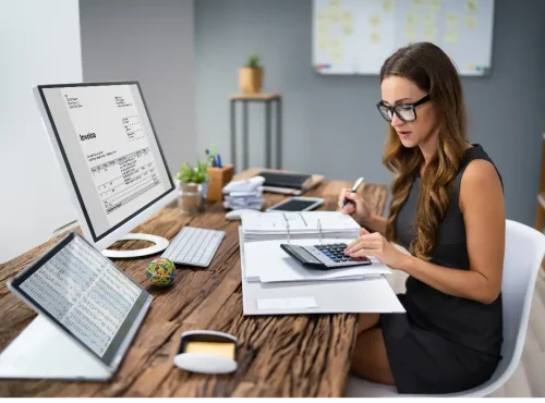 Accounts receivable billing specialist reviewing aged insurance claims and reimbursement data to recover unpaid revenue