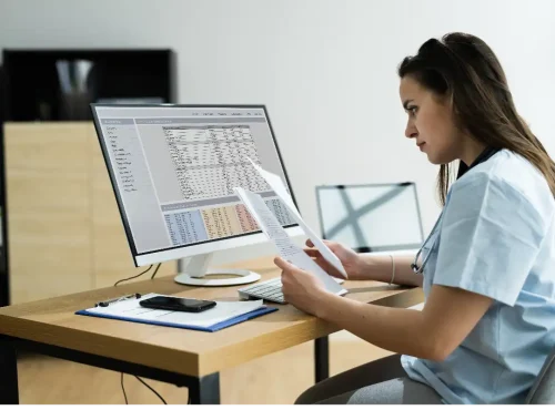Medical billing specialist reviewing claims data to ensure faster payments and fewer denials